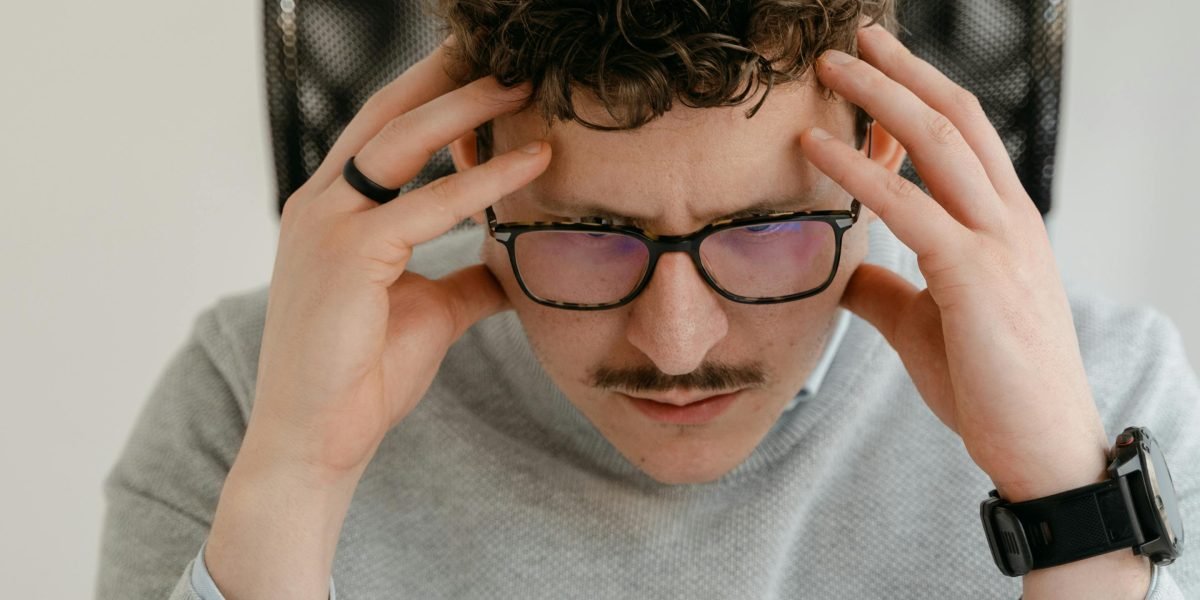 A person calmly analyzing a problem or error, demonstrating focused troubleshooting skills.