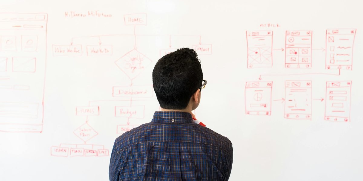 A person focused on strategic planning, symbolizing the foundational work required for a successful business.