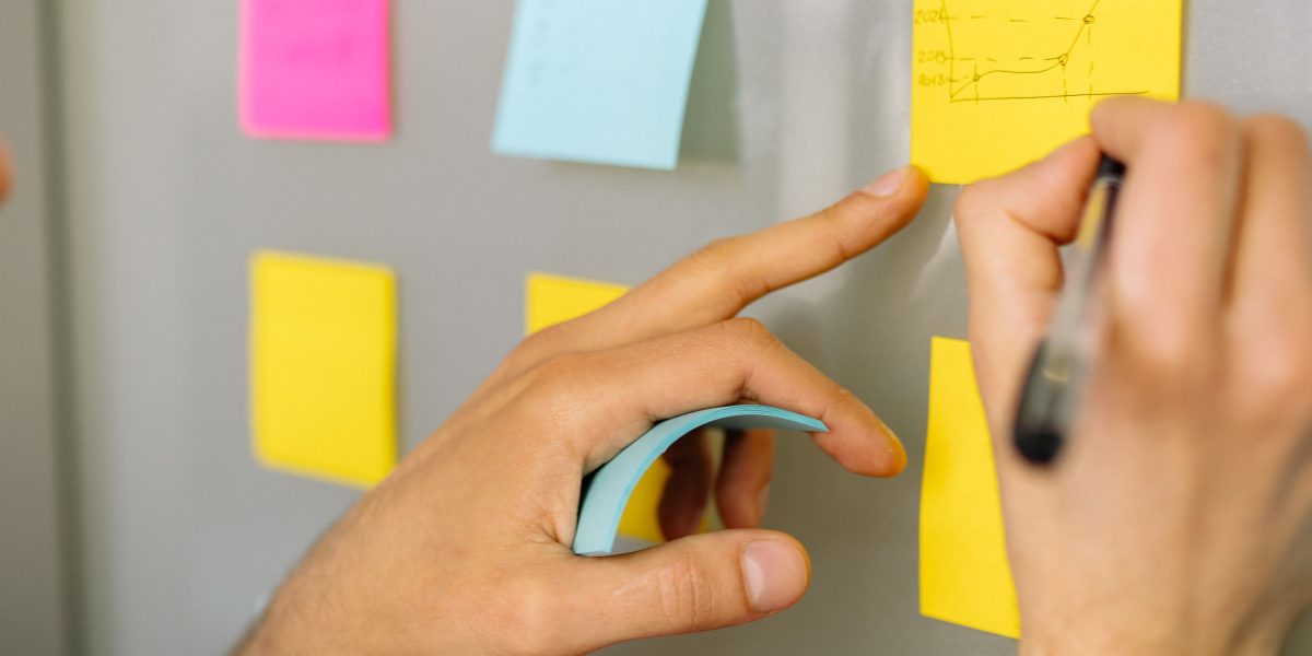 A person actively organizing their thoughts on a whiteboard, symbolizing the strategic management of YouTube settings.