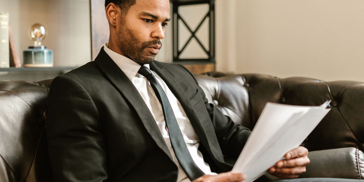 A person carefully reviewing documents, representing the diligence of an affiliate marketer verifying potential partners.
