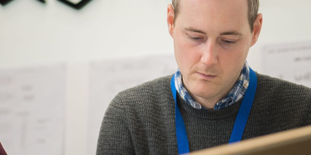 A person engaged in creative work, perhaps sketching or planning, representing the design phase of a blog.