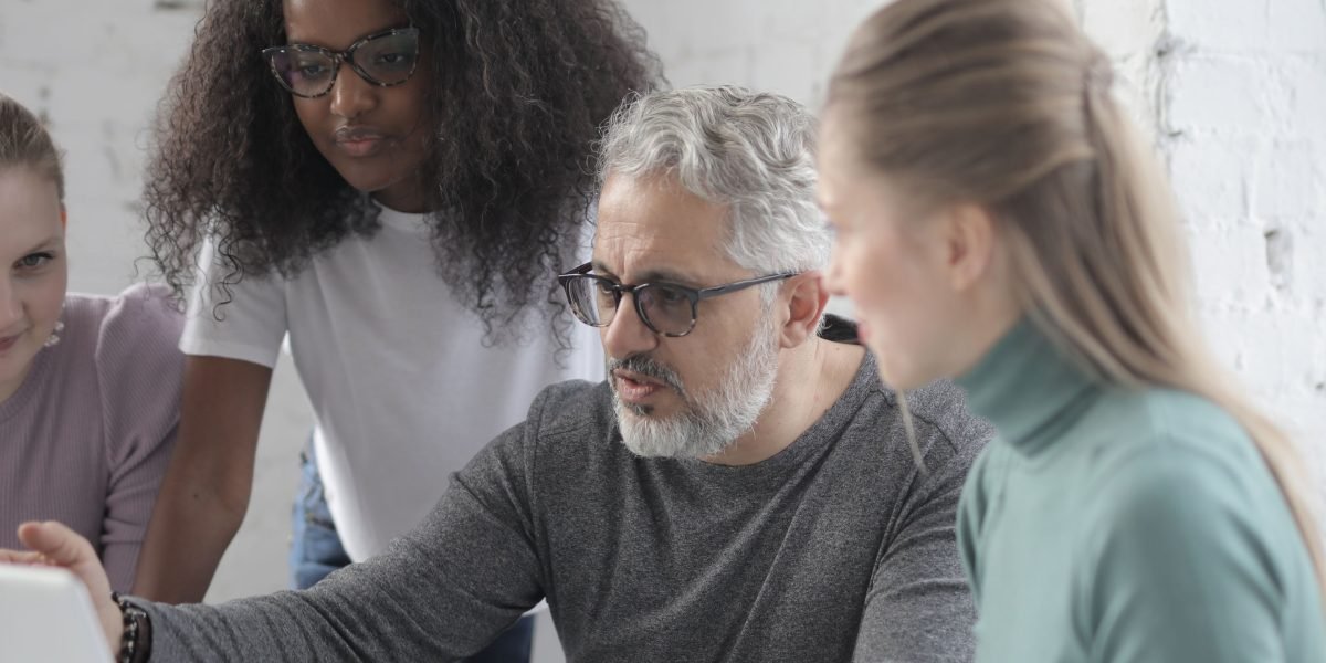 Team members collaborating to refine a workflow, representing the repeatable system of the Automated Affiliate Method.
